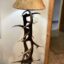 Unique Antler designs a floor lamp, that is a beautiful combination of large elk antler standing vertically, and bold moose antler laying horizontal, as a magazine holder. With a hand stitched rawhide shade. Every rosette is buffed smooth and polished to a shine.  The Height may vary from 50"-60" . We are happy to make it fit your style.