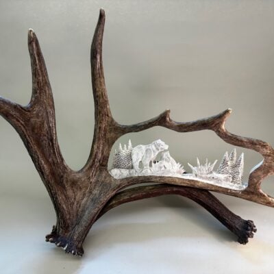 Unique Antler designs a carved moose antler of  mama bear with her cub.  This carving is based on a deer or moose antler. All hand carved with top grade antler.