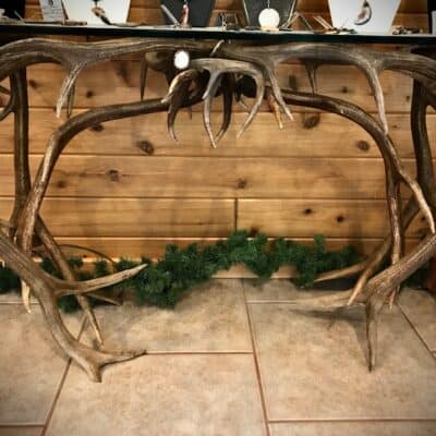 Unique Antler designs an Elk Antler Sofa Table that stands 28-30" tall x 17" wide x 50" long. For every table we individually hand select each antler. We use top grade antler when creating our tables to ensure everything is sturdy and well crafted. The ends of each antler rosette is buffed and polished to a shine.