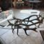 Unique Antler designs a large Elk Antler Coffee Table that comes with a 3x5'' glass. For every table we individually hand select each antler. We use top grade  antler when creating our tables to ensure everything is sturdy and well crafted. The ends of each antler rosette is buffed and polished to a shine.